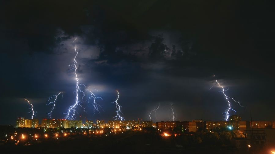 Lightning and clouds in the night sky over the city