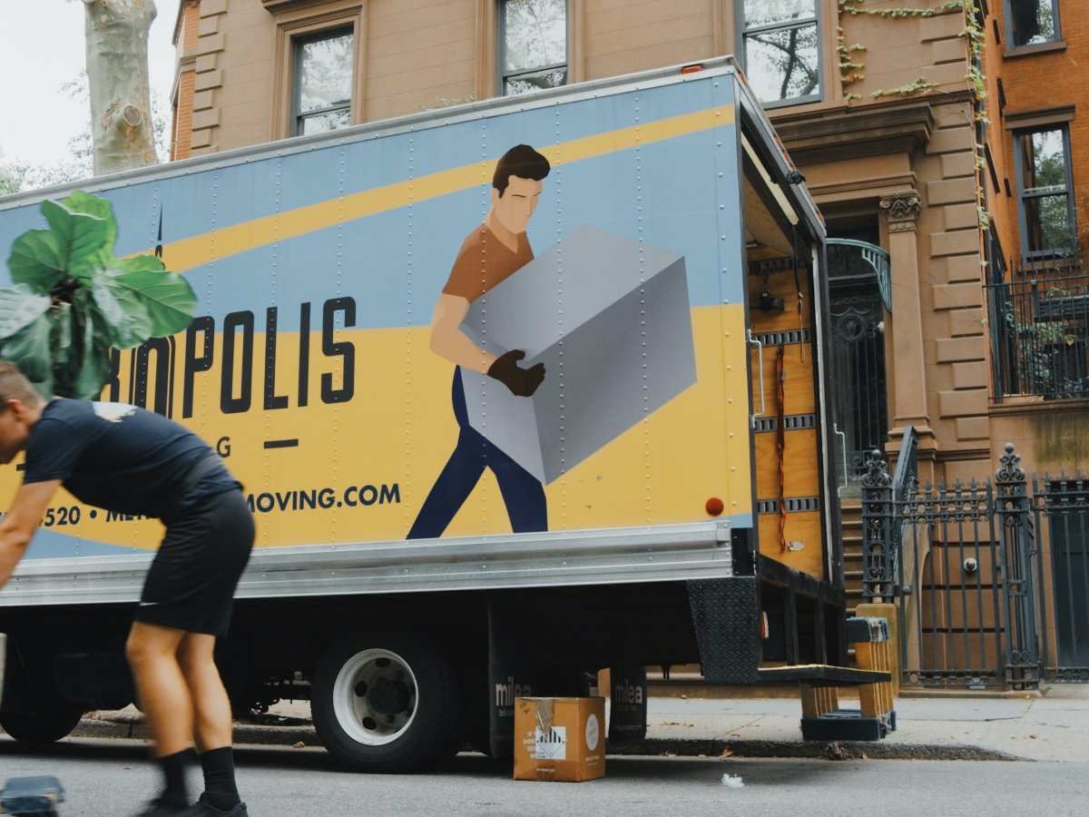 Moving van with people moving a plant