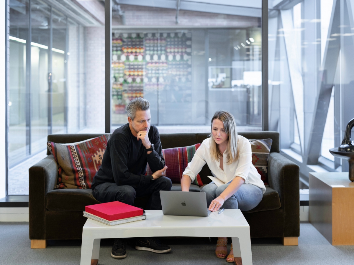 Two people working on laptop