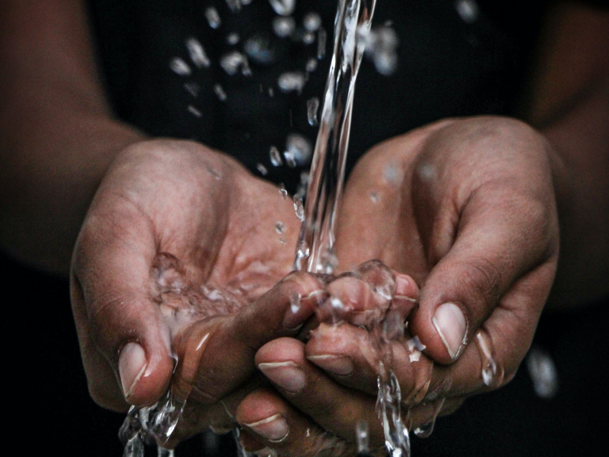 water falling onto a persons hands